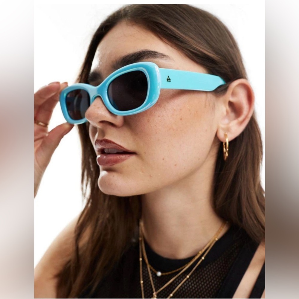 AIRE Bubble Oval Sunglasses in iridescent blue.